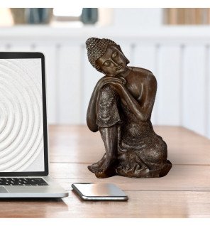  détail du visage serein de la statue bouddha penseur en résine couleur pierre