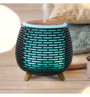  vue latérale du diffuseur tony compact à côté d’un livre et d’une tasse