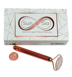 masseur visage électrique en quartz rose présenté dans son coffret cadeau raffiné