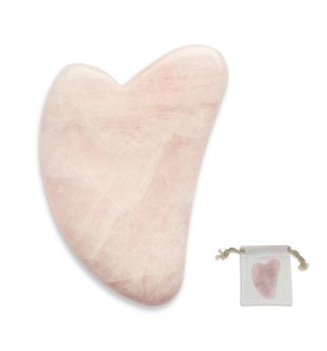 accessoire de soin beauté en quartz rose sur fond pastel pour ambiance relaxante
