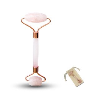 accessoire de massage facial dans une ambiance zen avec galets et feuilles vertes