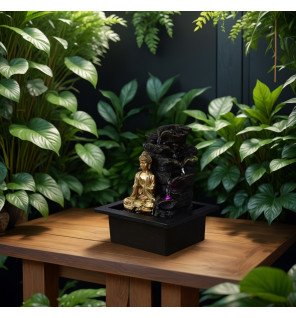  lumière led subtile illuminant la statuette bouddha et l'eau en cascade