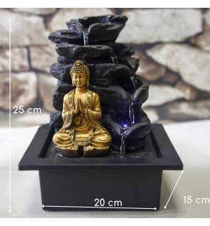  fontaine d'intérieur avec statuette bouddha et lumière tamisée pour une ambiance relaxante