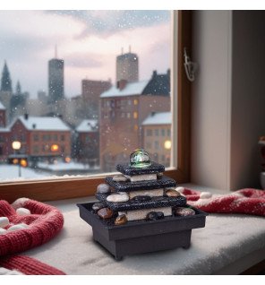  fontaine zen en résine noire avec eau qui s'écoule doucement pour créer une ambiance relaxante