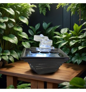  détail du jet d'eau apaisant coulant sur les éléments en verre transparent