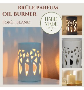  brûle-parfum blanc avec motif forêt utilisé pour diffuser des huiles essentielles
