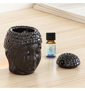  détail du visage de bouddha sculpté sur le brûle-parfum en céramique noire