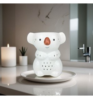  ambiance cocooning avec le brûle-parfum koko et un plaid en arrière-plan