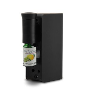  diffuseur rechargeable sans fil noir posé sur un meuble en bois clair dans une pièce lumineuse