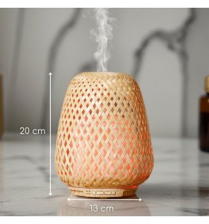  diffuseur d'huiles essentielles olaki dans une ambiance cocooning avec plaid et coussins