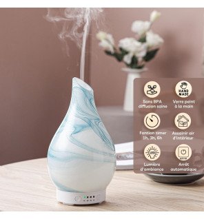  diffuseur d’huiles essentielles posé près de plantes vertes pour une atmosphère naturelle et relaxante