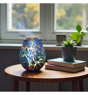  diffuseur posé près de livres et bougie pour créer une atmosphère relaxante