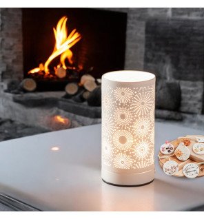  détail du design moderne et épuré du brûleur électrique posé près de livres et d’une plante