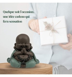  ambiance relaxante créée par la présence d’une statuette bouddha rieur bébé près d’une bougie allumée