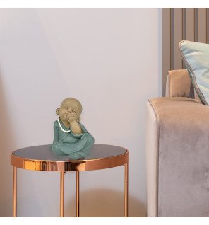  statue bonze silence placée près de plantes vertes pour une atmosphère harmonieuse