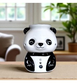 panda brûle-parfum en céramique de la marque zen'arôme posé sur une table en bois clair