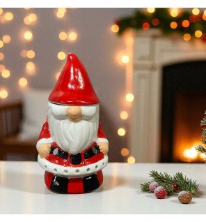  détail du visage souriant du père noël sur le brûle-parfum avec lumière tamisée