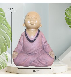  décoration intérieure mettant en valeur la statue bébé bouddha rose dans un coin lecture cosy